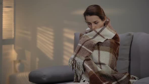 Lonely Depressed Female Sitting on Couch, Covered With Plaid, Unemployment