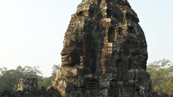 Back to Back Smiling Faces Carved on the Stone Ruins in Cambodia Temple alt