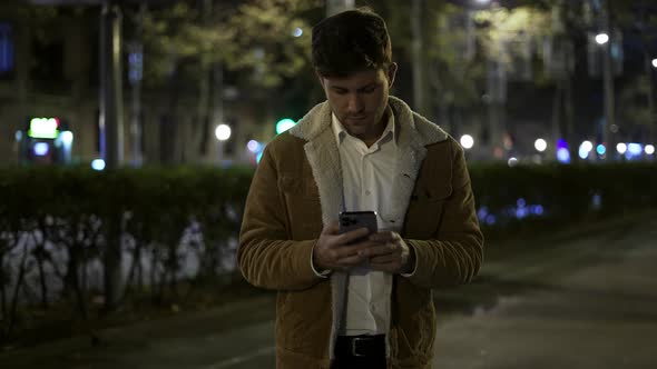 Positive Man Browsing Social Media in Evening