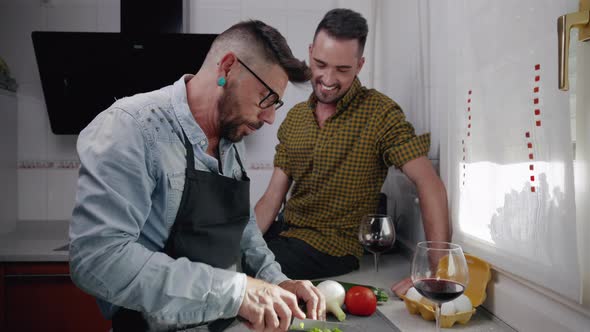 Happy Hipster Gay Couple in Love Standing in the Kitchen