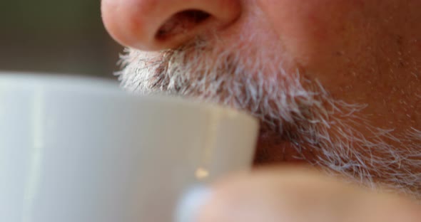 Senior man having coffee at home 4k