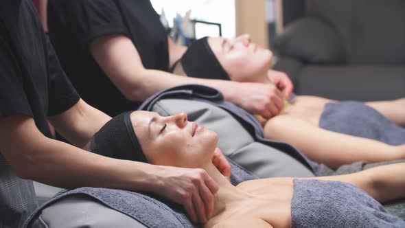 Young Women at the Spa Enjoy Facial and Cleavage Treatments