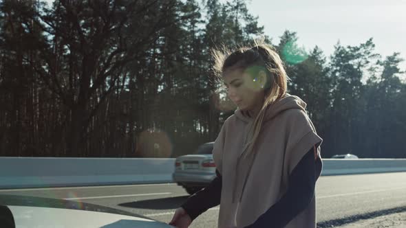 The Woman Opens the Hood of the Car and Smoke Comes From the Engine