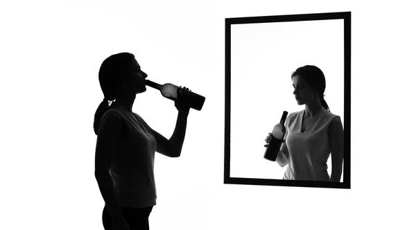 Drunk Woman With Alcohol Bottle Looking in Mirror, Conscience Asking to Stop