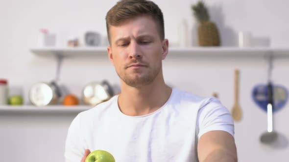 Handsome Man Having Fun Juggling Apples in Kitchen, Talent, Leisure Activity