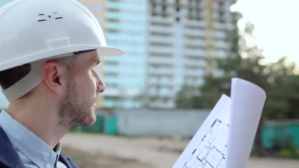 Construction engineer looking at building blueprints