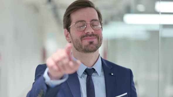 Assertive Young Businessman with Pointing at the Camera