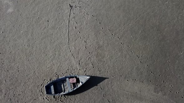 Top View of Boat at Shore of Dried Up Sea Global Warming and Drought Concept