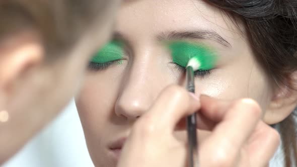 Makeup Artist Applying Green Eyeshadow