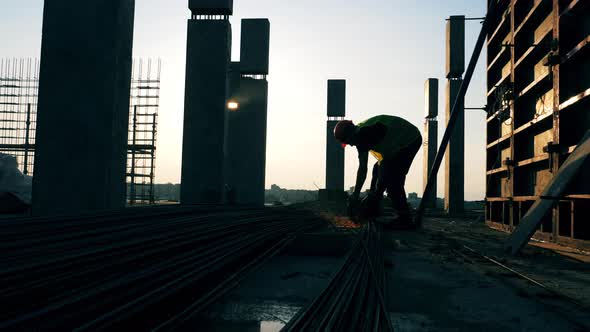 A Worker Uses Disk Saw on a Construction Site.