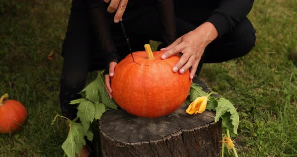 Daughter and Father Hands Cut Pumpkin for Halloween