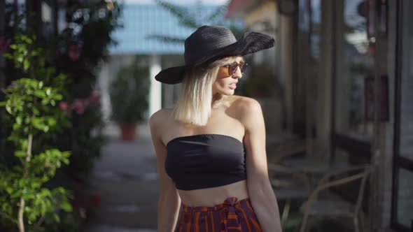 Portrait of an Attractive Smiling Young Woman in a Hat