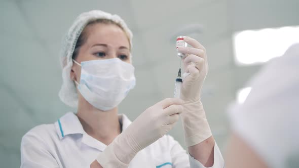 Medical Worker is Filling a Syringe with Coronavirus Vaccine