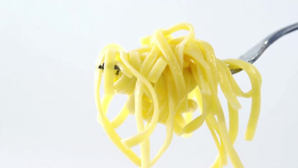 Close-up of cooked pasta on fork