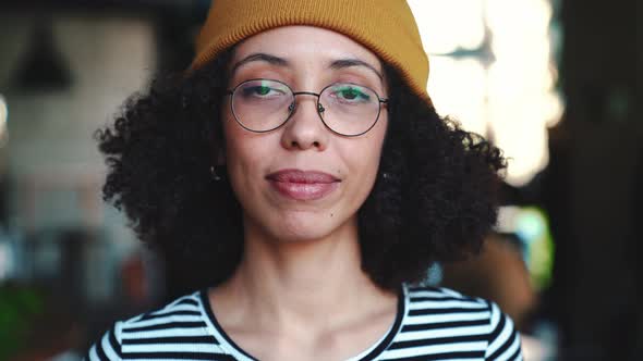 Cheerful woman wearing hat opening eyes at the camera