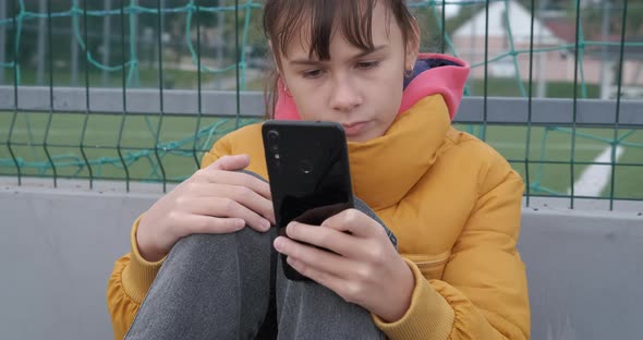 Teen with Telephone on Playground