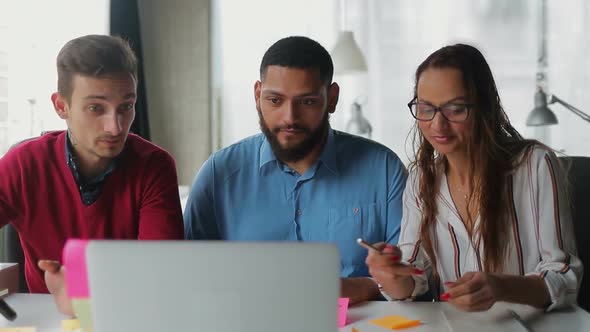 Smiling Managers Discussing Business Issues Through Laptop