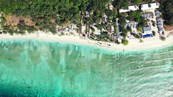 Natural aerial island view of a white sand paradise beach and blue water background in colourful 4K