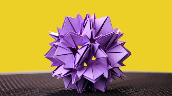 Beautiful Origami Flower on Yellow Background.