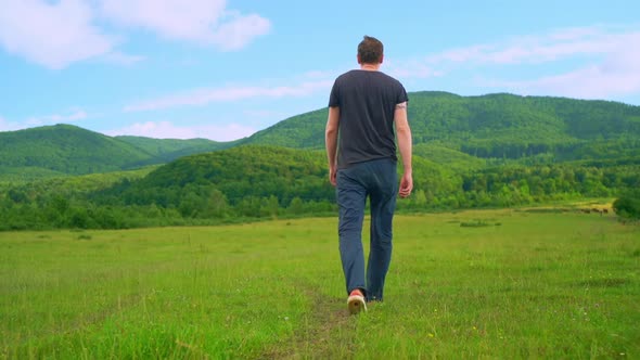 Rear Man Walking on Field