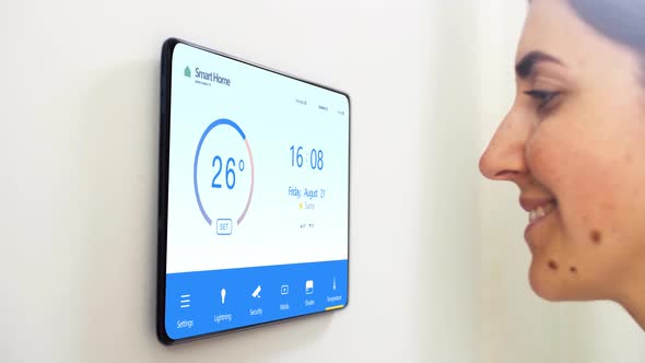 Woman Looking at Tablet Computer at Smart Home