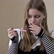 Teenage Girl Looks Fearfully at a Pregnancy Test - VideoHive Item for Sale