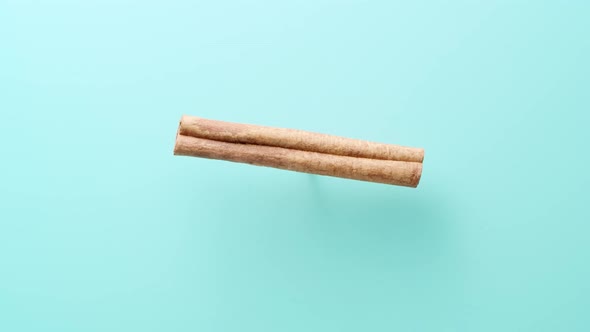 Cinnamon Stick Rotating on Blue Cyan