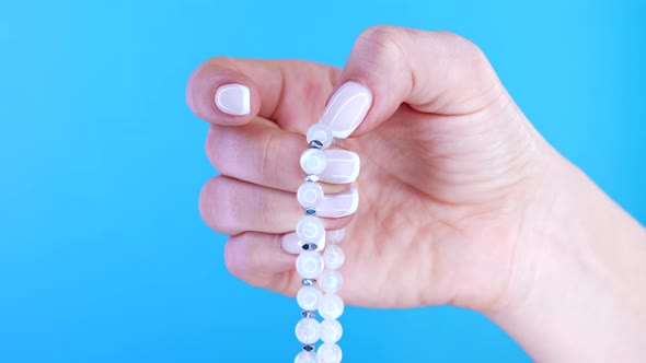 Woman Lit Hand Counts Mala Beads Strands of Gemstones Used for Keeping Count During Mantra