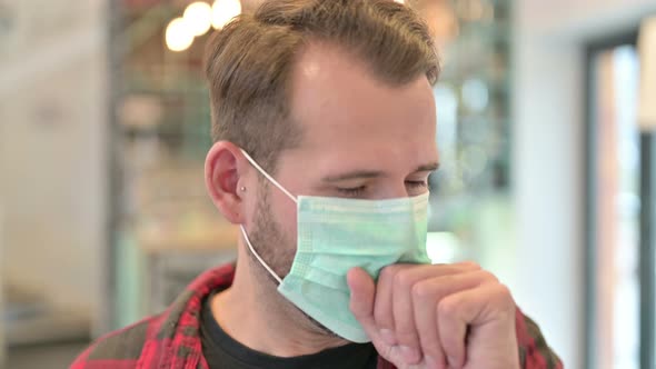 Portrait of Young Man with Face Mask Coughing 