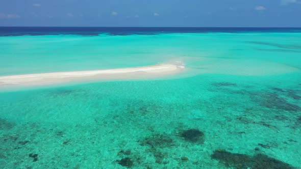 Luxury birds eye tourism shot of a white sand paradise beach and aqua blue ocean background 