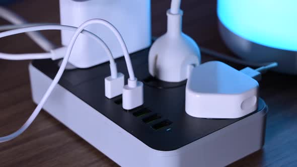 Closeup of a Male Hand Unplugging Cables From the Power Outlet