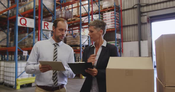 Warehouse managers working together in loading bay 4k