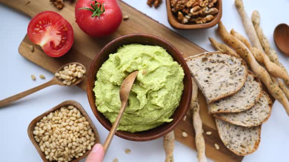 Homemade Avocado Guacamole Dip In Wooden Bowl On Table