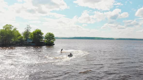 A Man Flying Around Over the Water on the Flyboard  Aerial View
