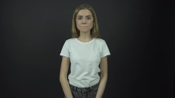 Sad Lady in White T-shirt Breathes Deeply and Looks Straight