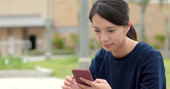 Woman use of mobile phone at outdoor park