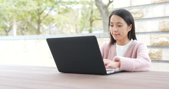 Woman use of notebook computer at outdoor