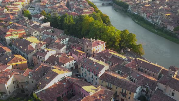 Aerial view of Verona City with bridges across Adige river. Medieval buildings with red tiled roofs