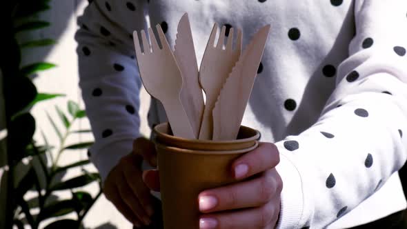 Slow Motion Female Hands Holding Wooden Forks and Paper Cups with Plates