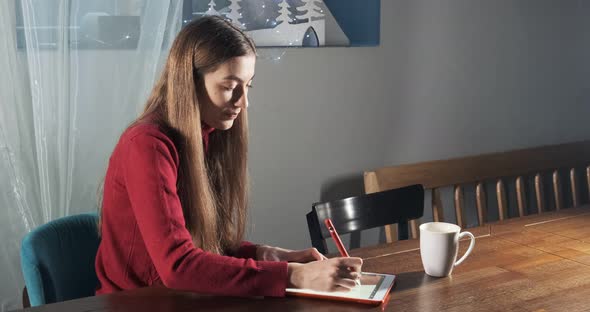 Talented Innovative Pretty Female Designer Sitting and Working at Desk. Contemporary Young Woman