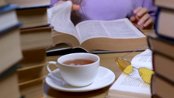 Female Hand Flipping Through the Pages of a Book Closeup