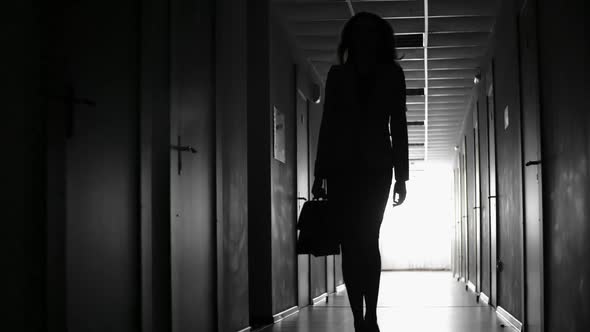 Backlit of Businesswoman Walking