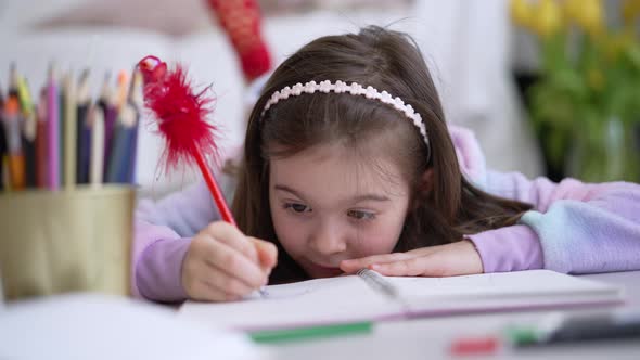 Girl Doing Homework on Bed