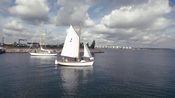 Two Old Classic Sailboats Pass Each Other On The Way To Port