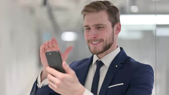 Young Businessman Loss on Smartphone