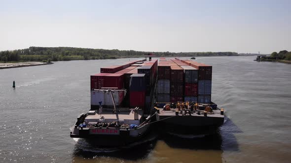 Two Barges With Bulk Of Shipping Containers Sailing In The River n A Sunny Summer Day In Netherlands