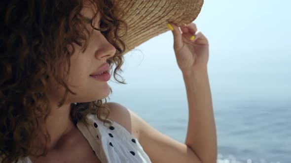 Portrait Luxurious Woman Wearing Straw Wide Brimmed Hat on Sunny Beach