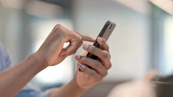 Hands of African Man Using Smartphone