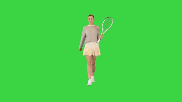 Female Tennis Player Walking and Tossing a Ball Up on a Green Screen Chroma Key