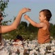 A Young Mother Feeds Her Young Son Cherries - VideoHive Item for Sale